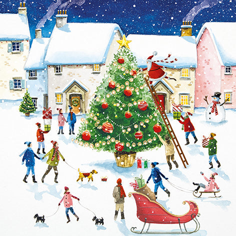 Christmas card design showing a village scene where people are walking dogs and sledding by a large Christmas tree.
