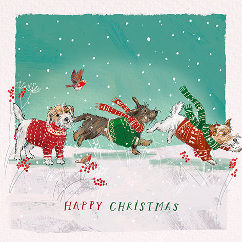 Christmas card design showing dogs wearing jumpers and scarves in the snow, text reads 'Happy Christmas'.