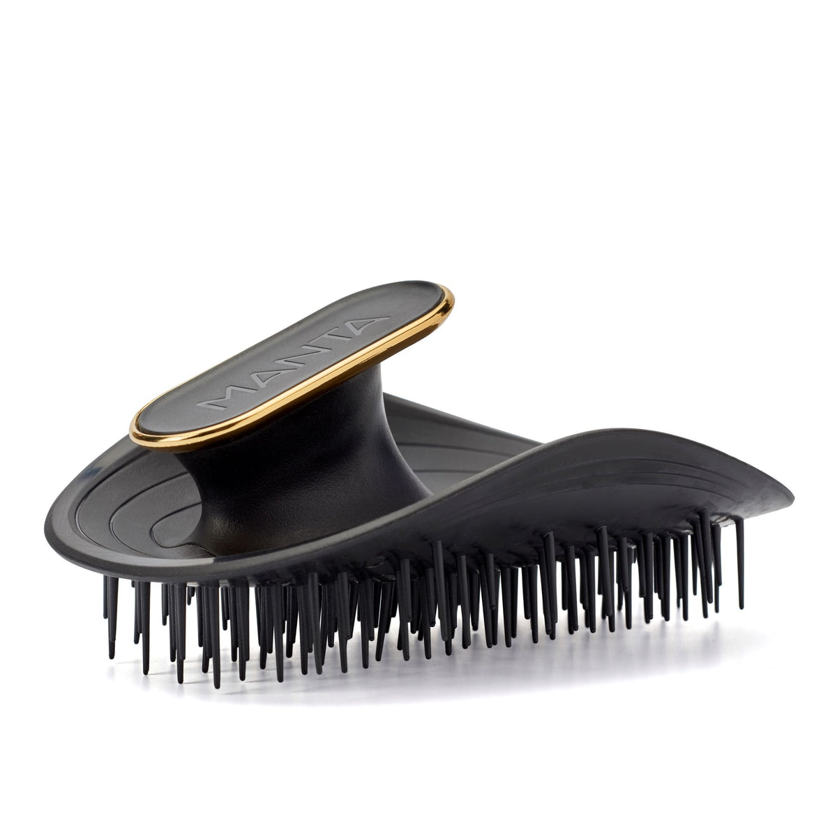 Black MANTA hairbrush with gold accent on a white background.