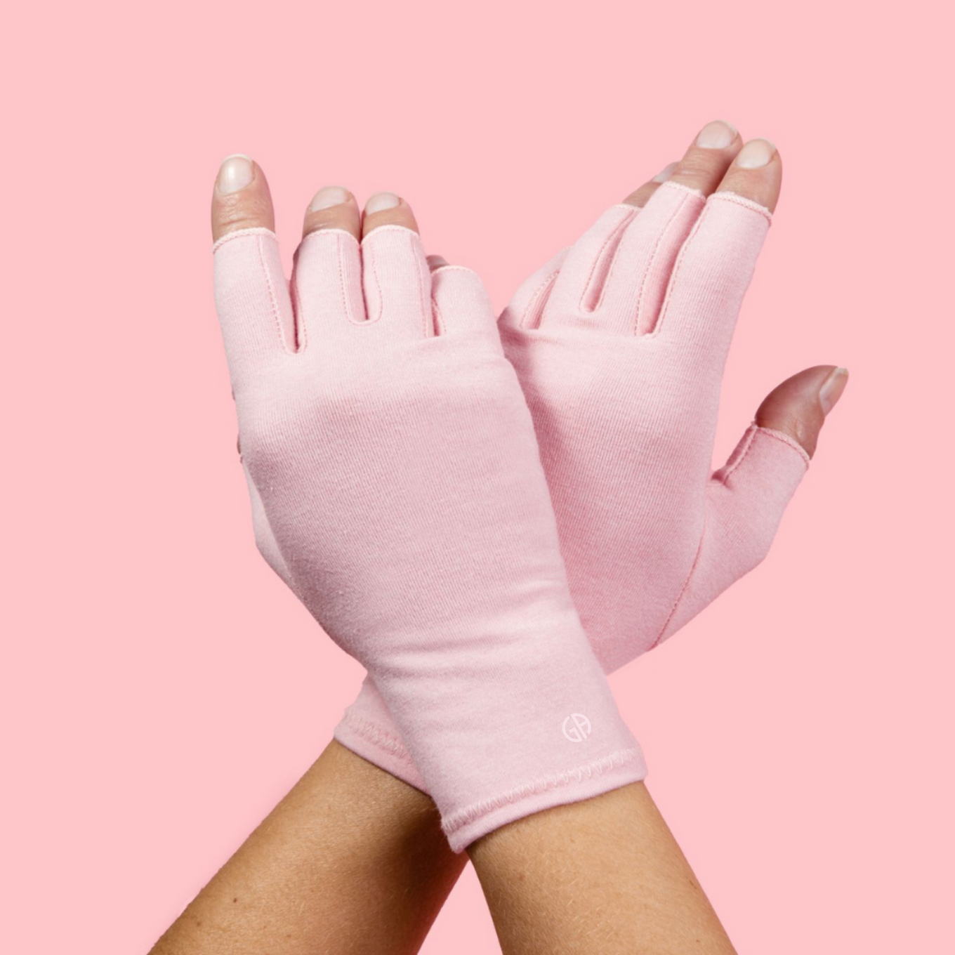 A pair of ballet pink compression gloves designed to alleviate joint pain.