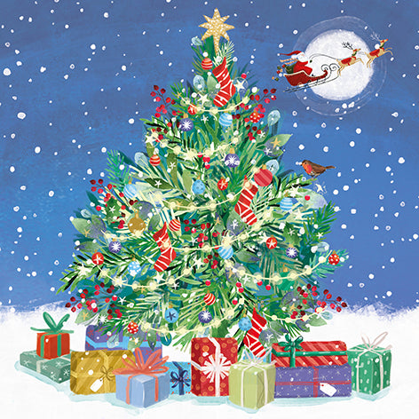 Christmas card design showing a decorated Christmas tree with presents and Santa in sleigh against a snowy night sky