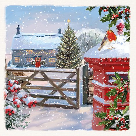 Christmas card design showing a winter scene with a snowy house, tree, and red postbox.