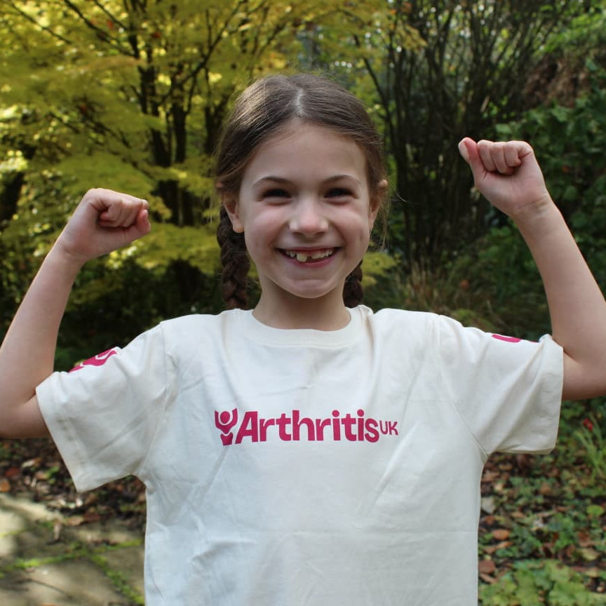 Girl wearing a white t-shirt with Arthritis UK logo.