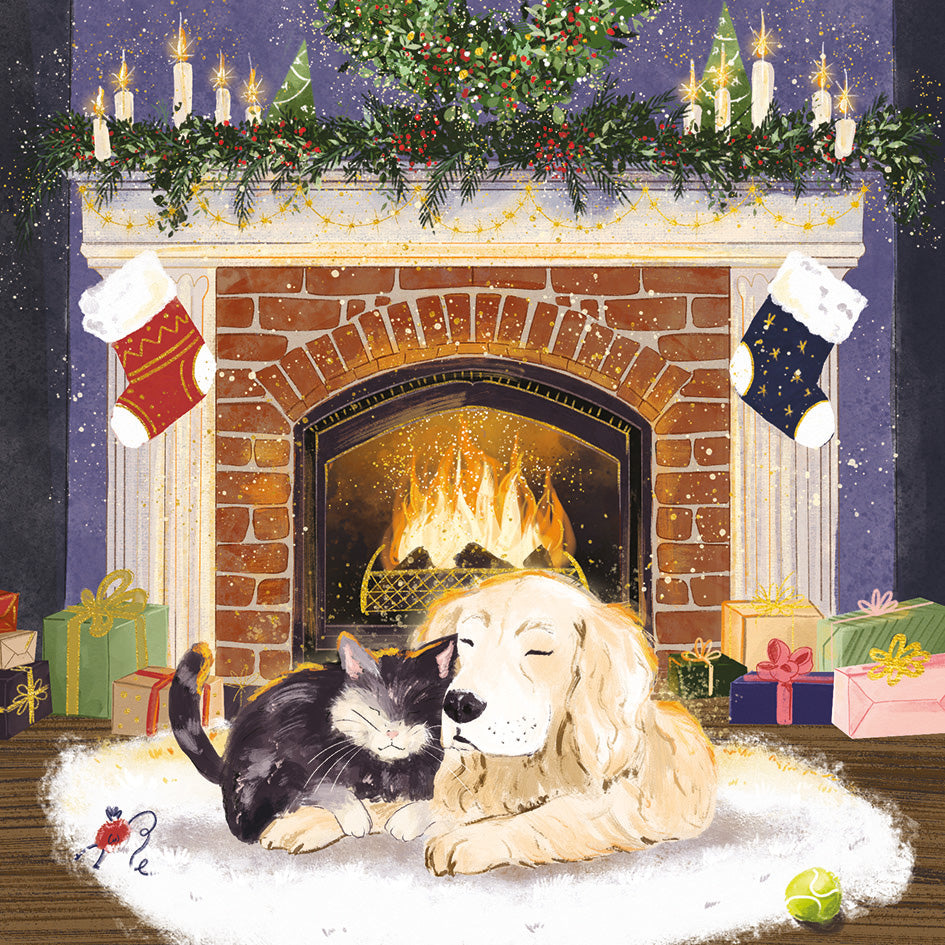 Front cover of the Arthritis UK Christmas Card 'Cosy Cuddles' featuring an illustrated cat and dog cuddling in front of a roaring fireplace, decorated with holly, candles and stockings. 