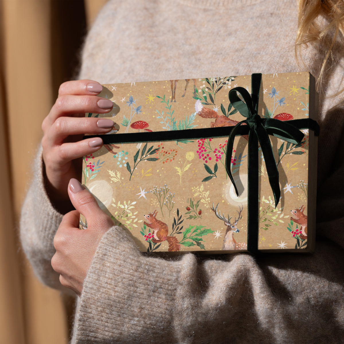 Gift wrap featuring squirrels, deer and forest plants. 