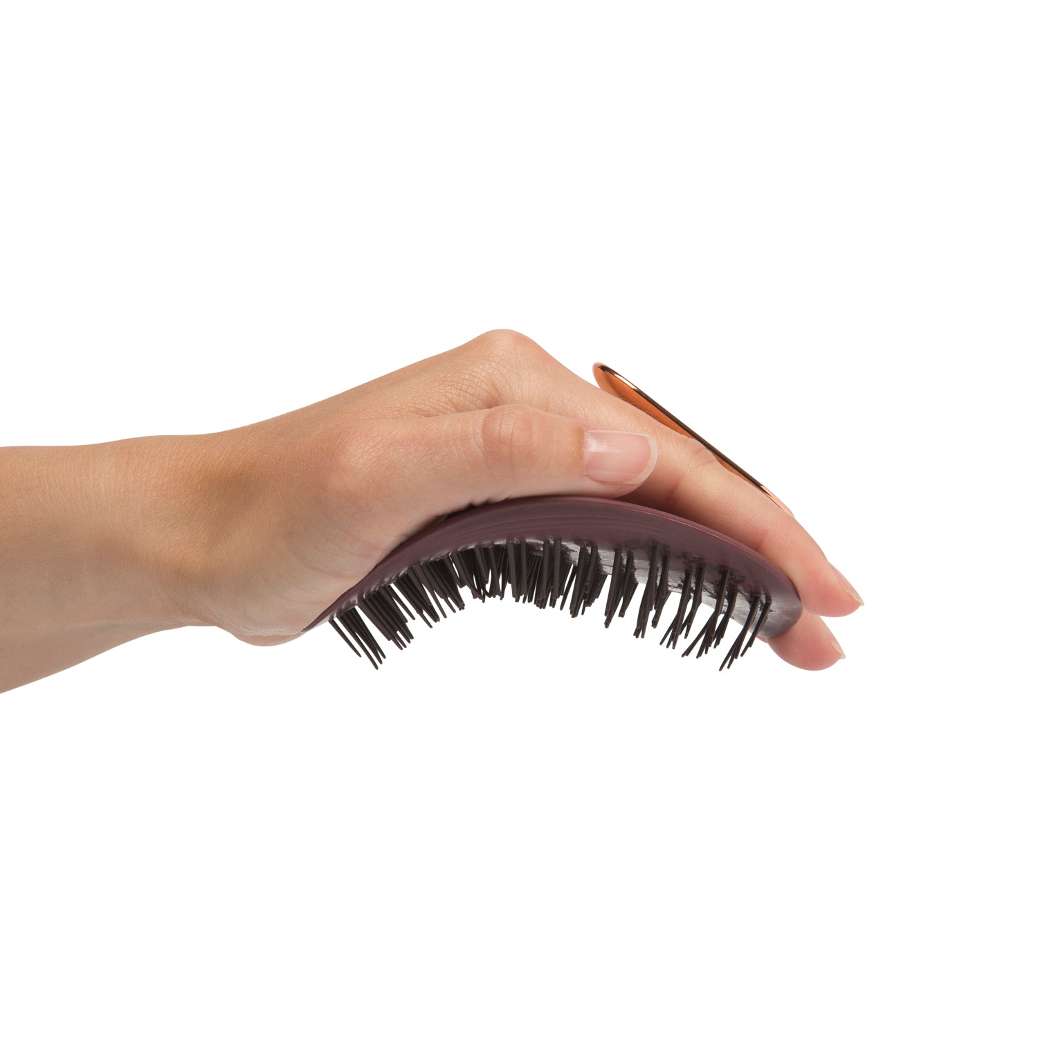 MANTA easy grip brush in burgundy and rose gold, being held and flexed in the hand. 