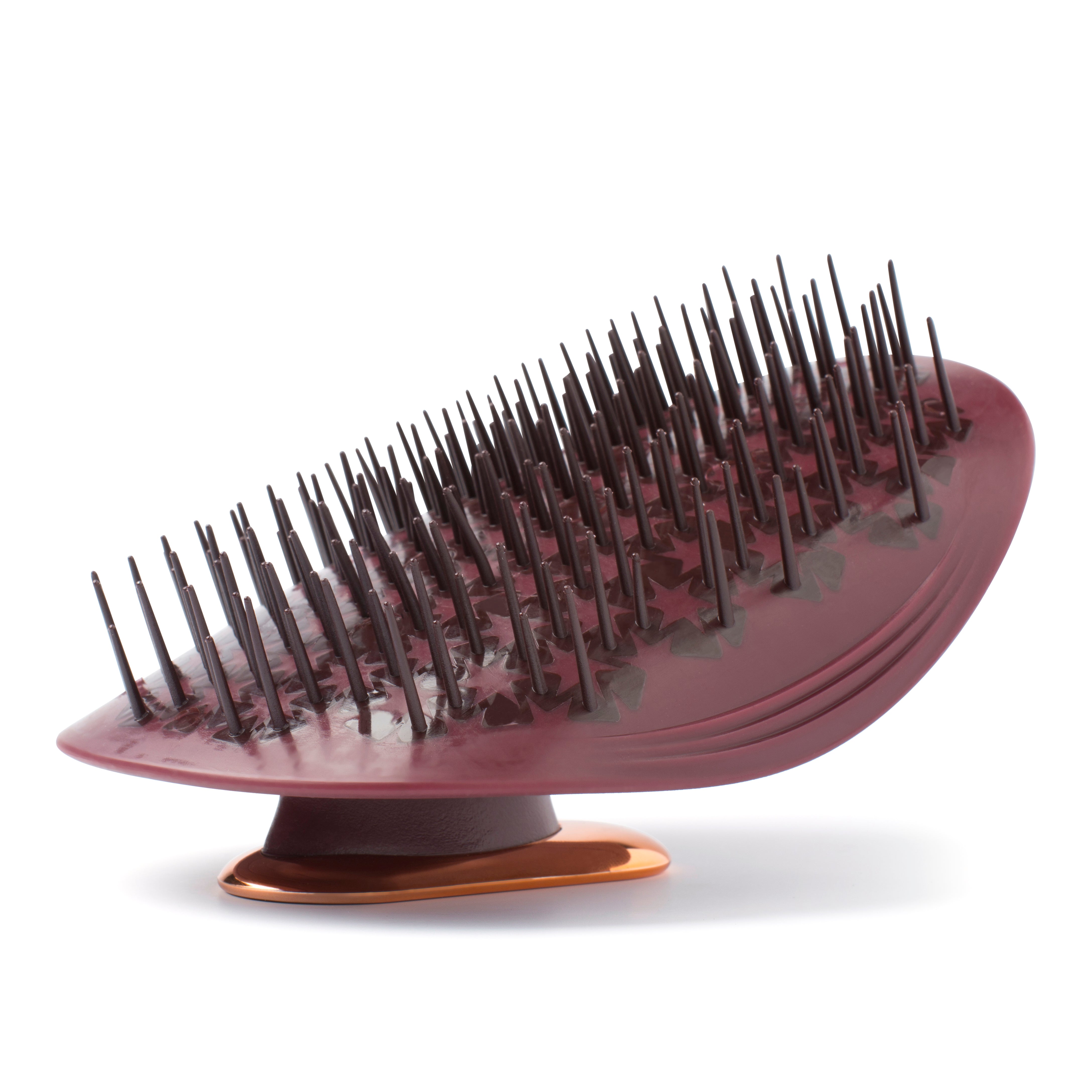 MANTA brush in burgundy and rose gold, shown bristles side up on a white background.
