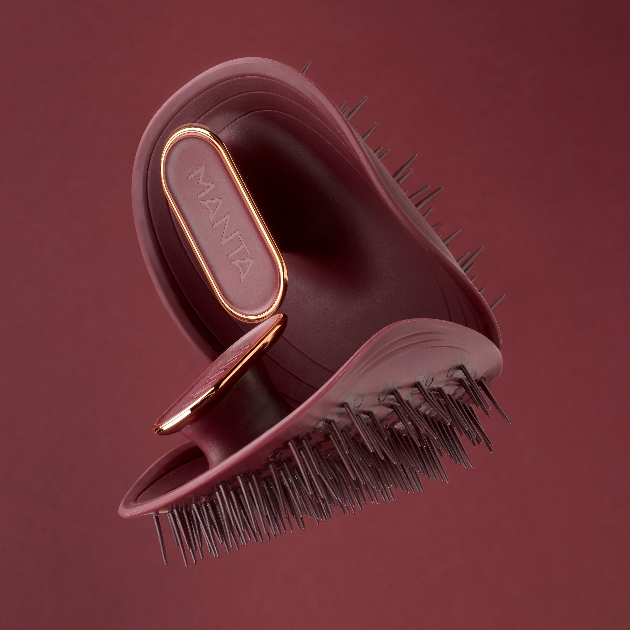 MANTA lightweight brush in burgundy and rose gold.