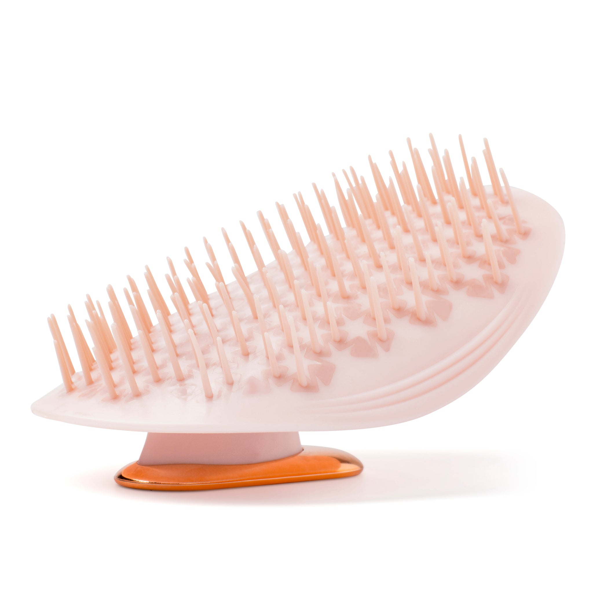 MANTA easy grip brush in pink and rose gold, bristles side up. 