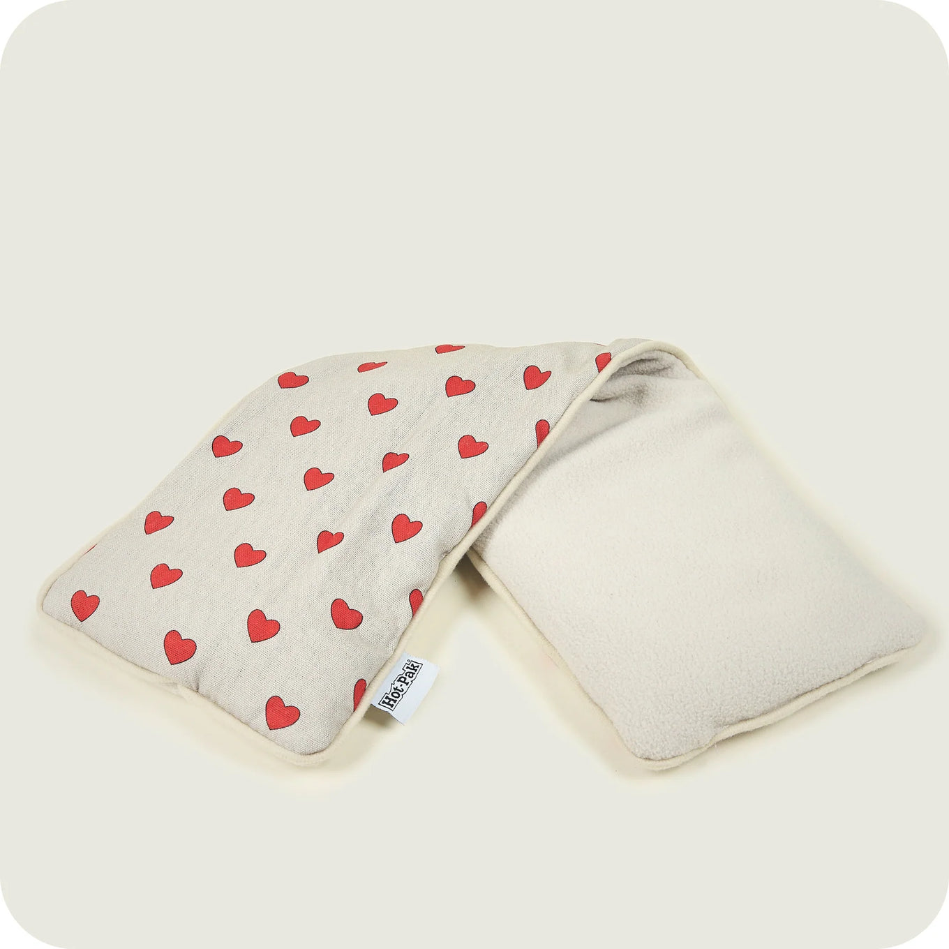 Microwavable Hot-Pak heat pack with lavender scent with a pattern featuring red hearts.