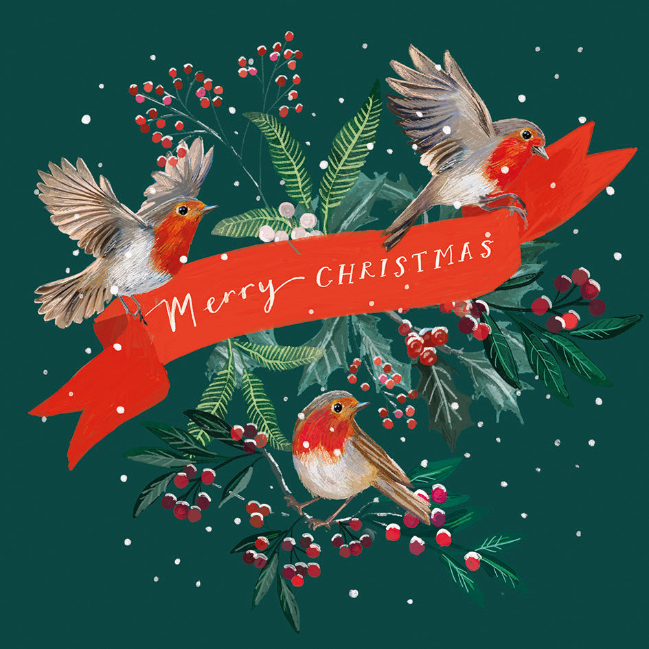 Front cover of the Arthritis UK Christmas Card 'Red Ribbon' featuring three robins holding up a red ribbon, in front of winter leaves. The red ribbon reads 'Merry Christmas'. 