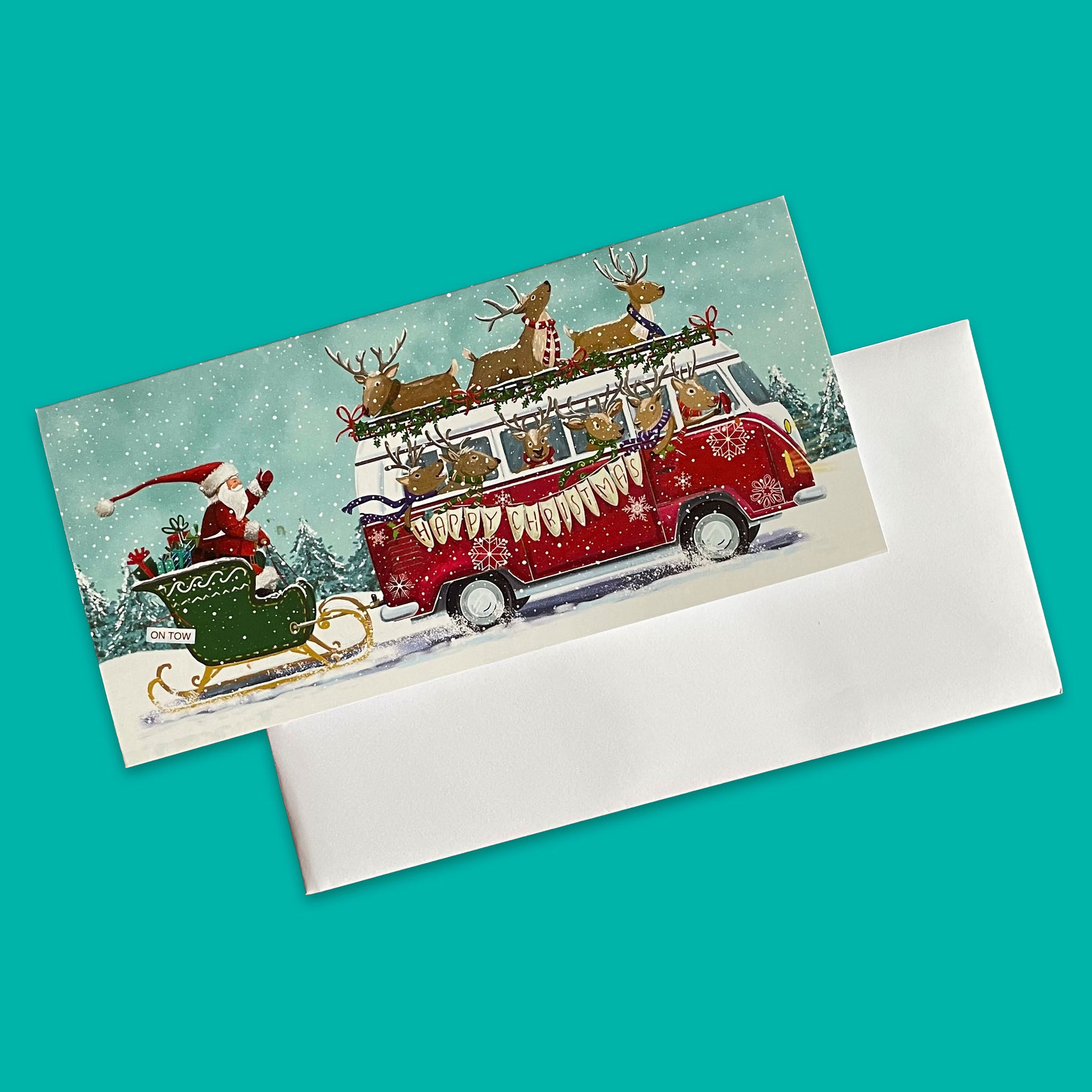 Illustrated Rudolph to the Rescue wallet card with Santa’s sleigh hitched to a reindeer-driven campervan in a winter scene.