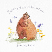 Watercolor-style illustration of a two bears hugging, with the text 'Thinking of you at this sad time' above and 'Sending hugs' below, on a white background with small flowers and butterflies.