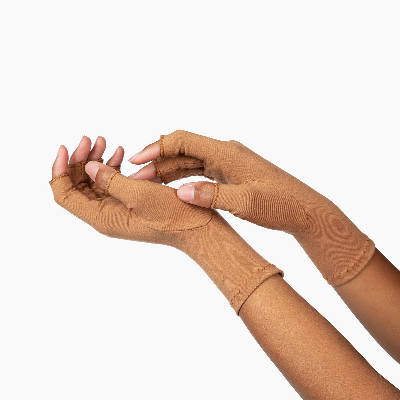 Hands wearing cinnamon brown compression gloves