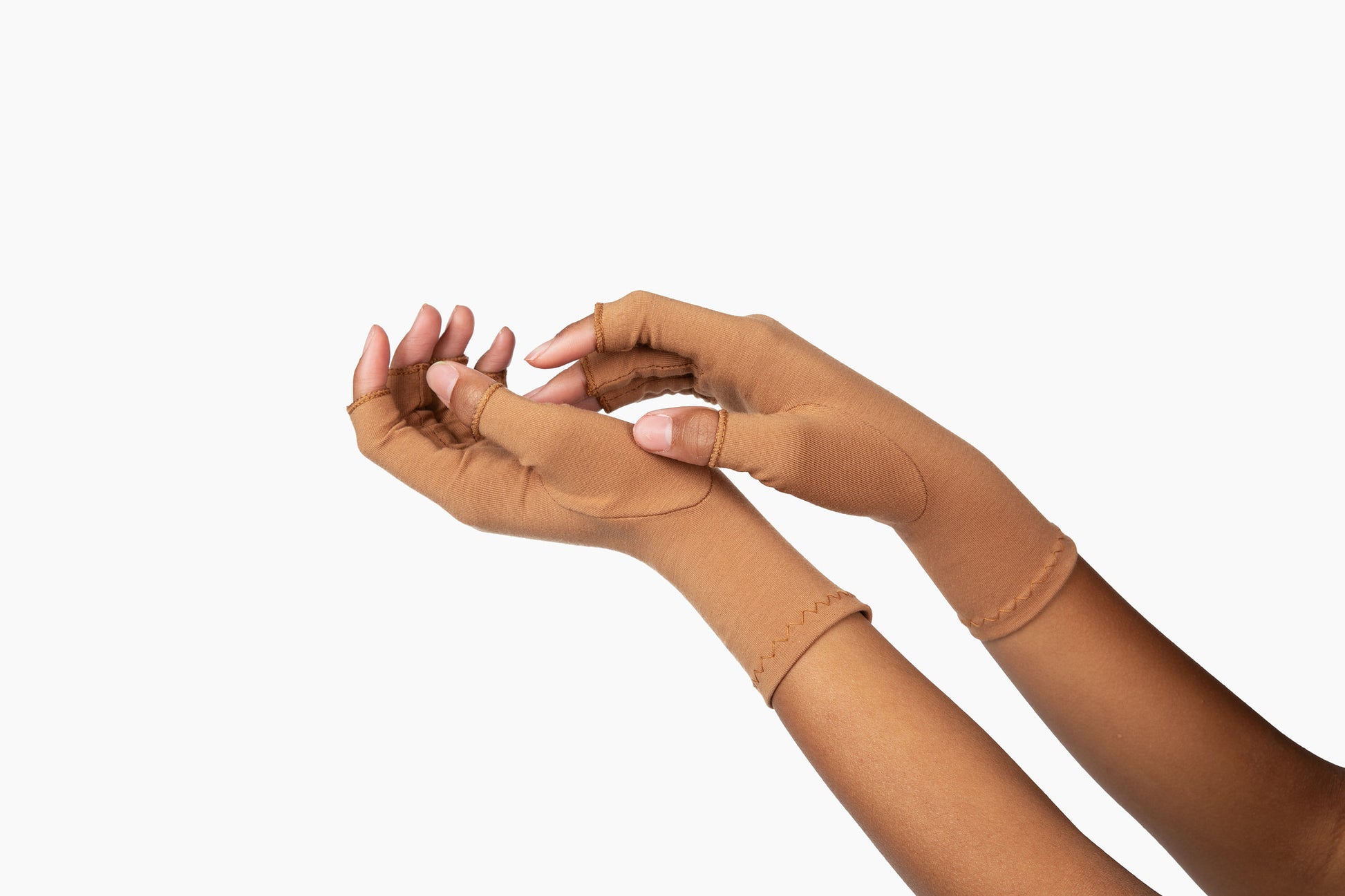 Hands wearing cinnamon brown compression gloves