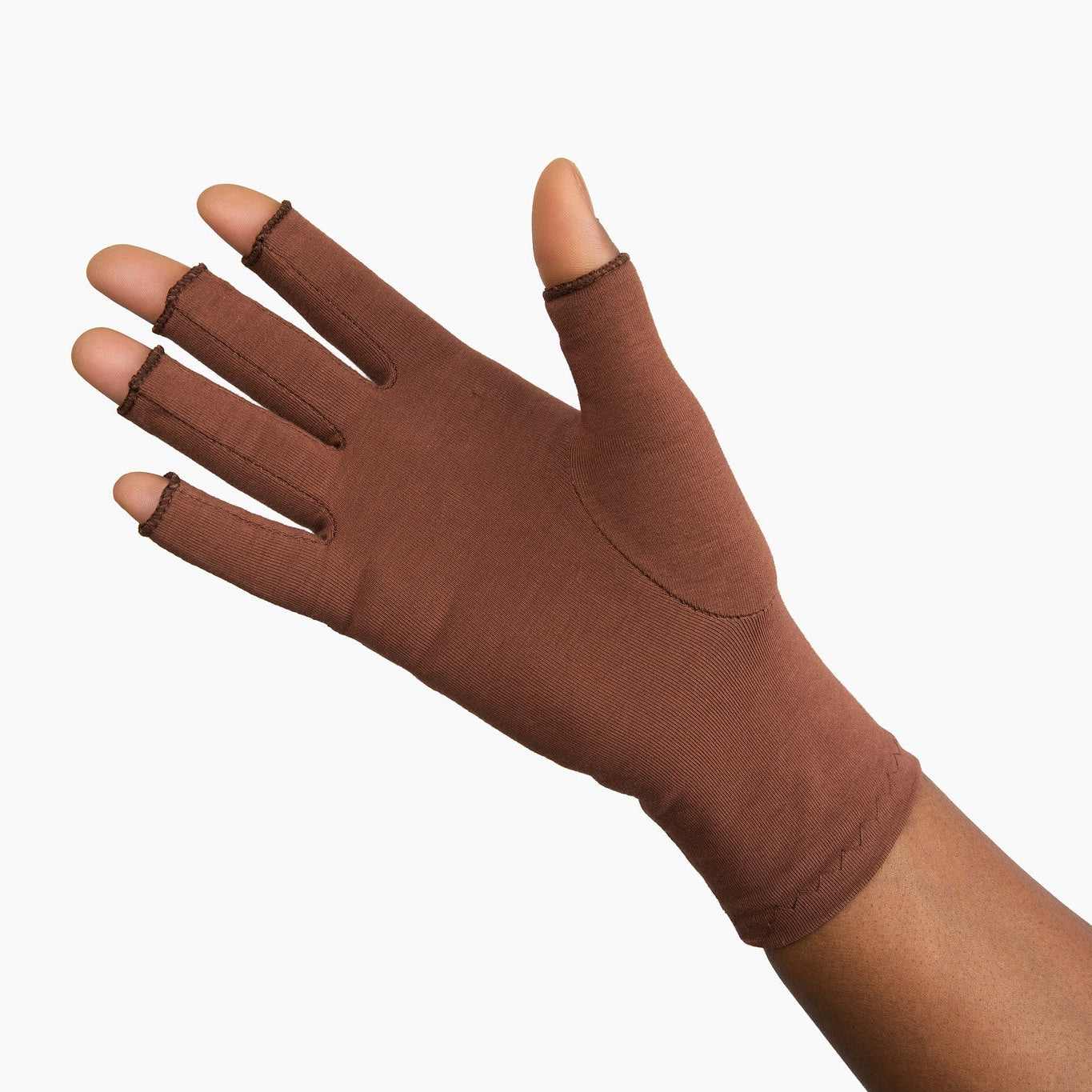 Hand wearing Grace and Able cocoa compression gloves showing palm