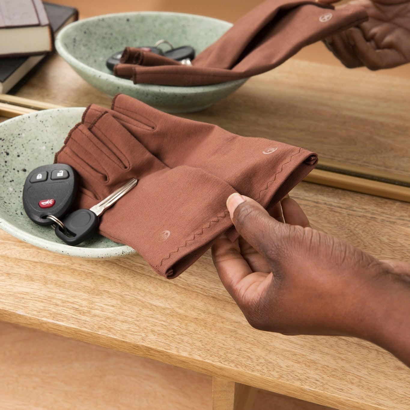 Grace and Able cocoa compression gloves sitting in key bowl