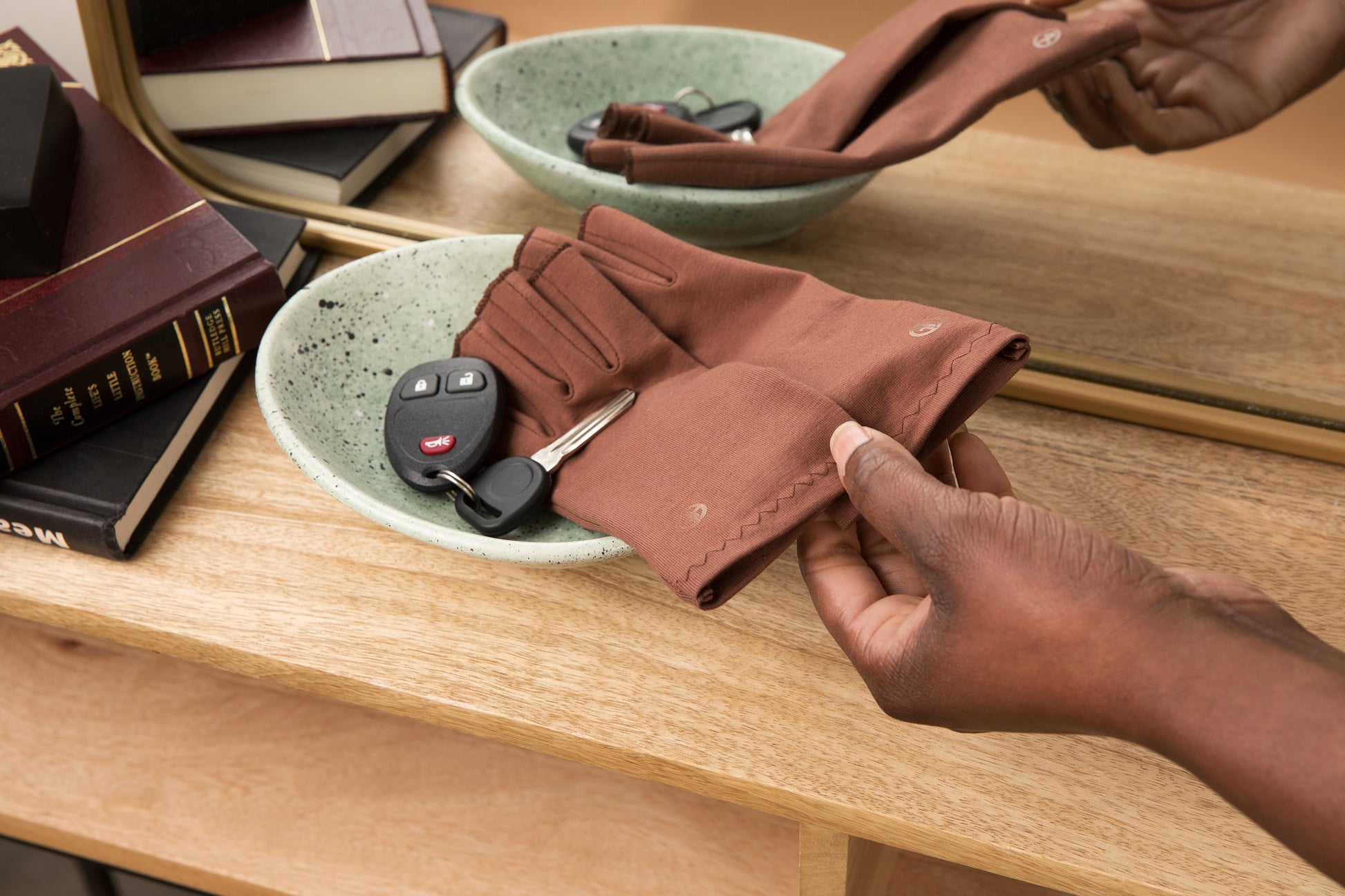 Grace and Able cocoa compression gloves sitting in key bowl